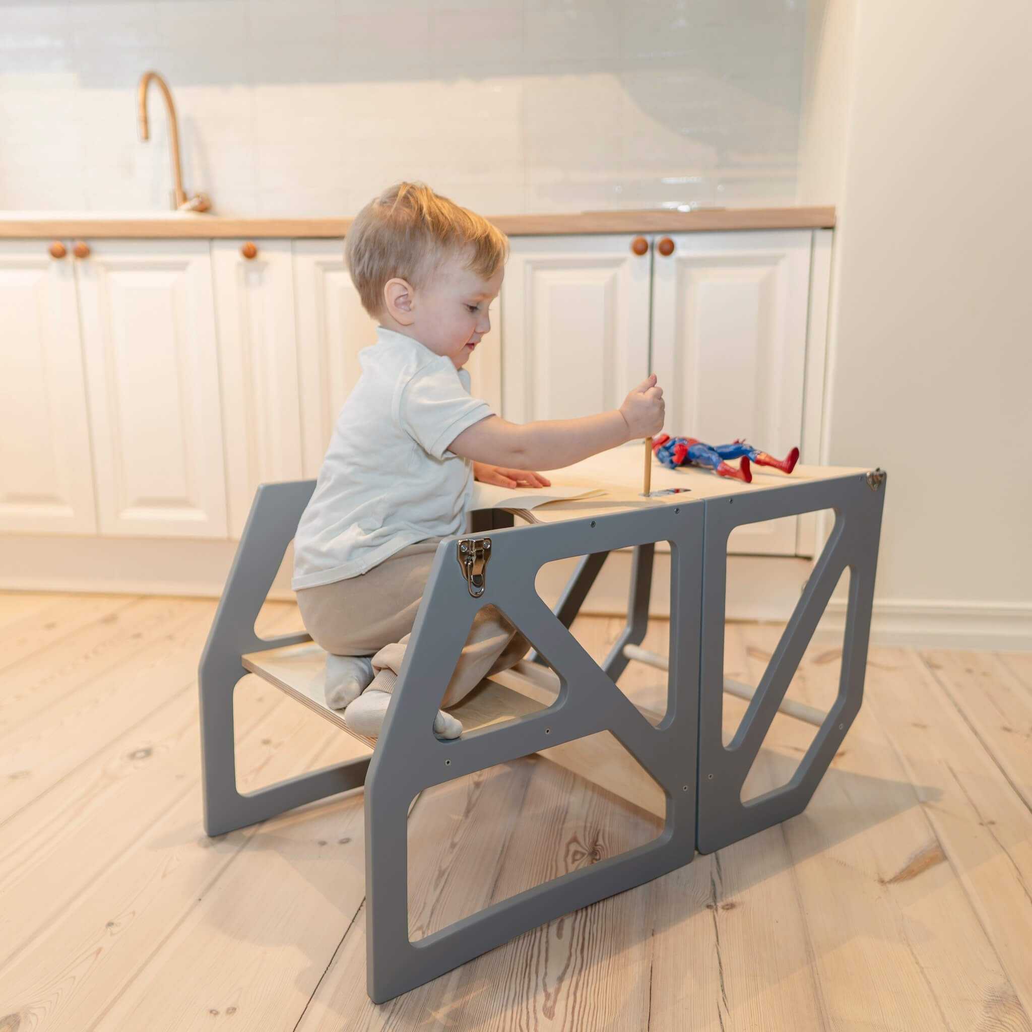 Gray transformable kitchen tower converted to table mode for play and learning