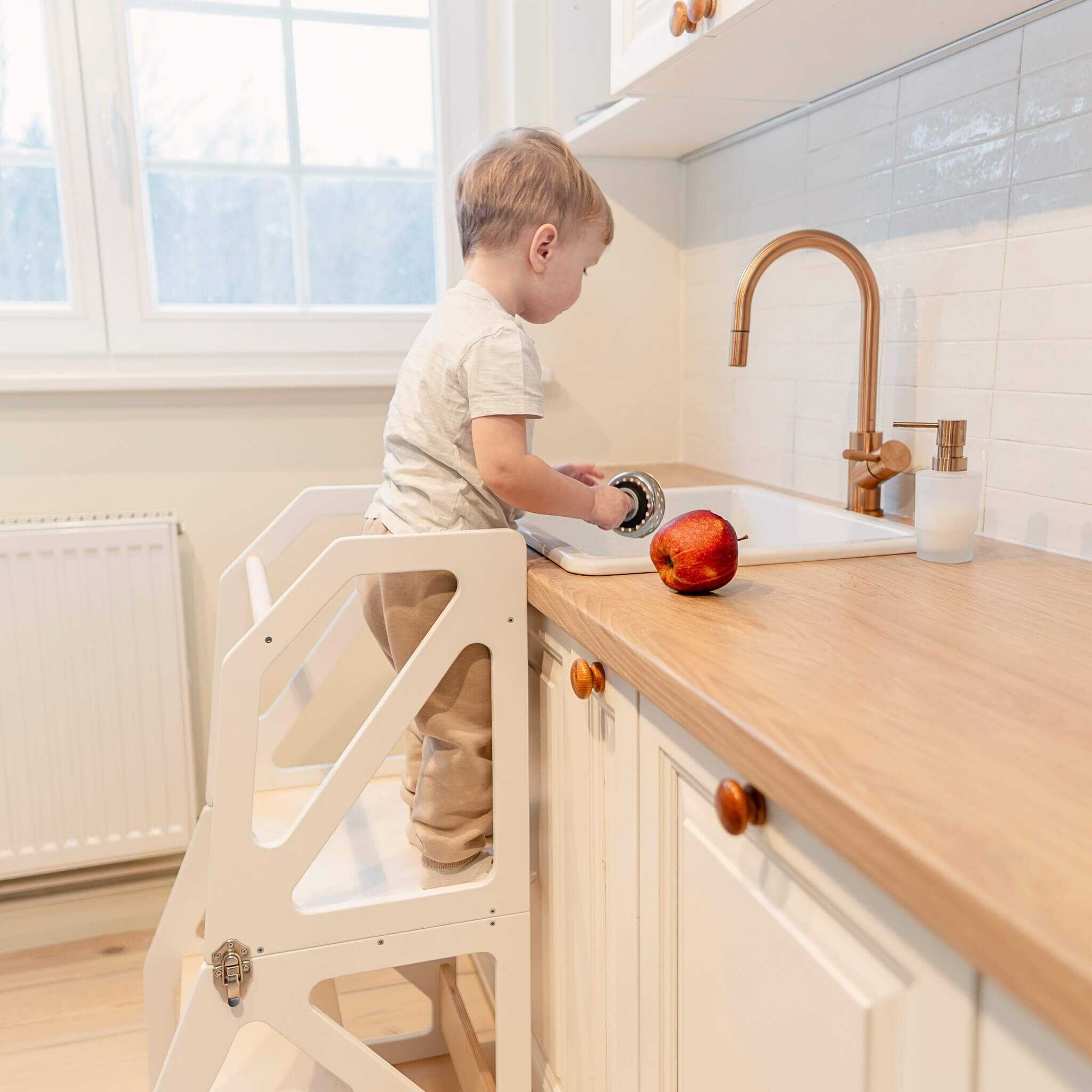 Toddler standing in transformable kitchen tower, safe and sturdy 2-in-1 kitchen helper